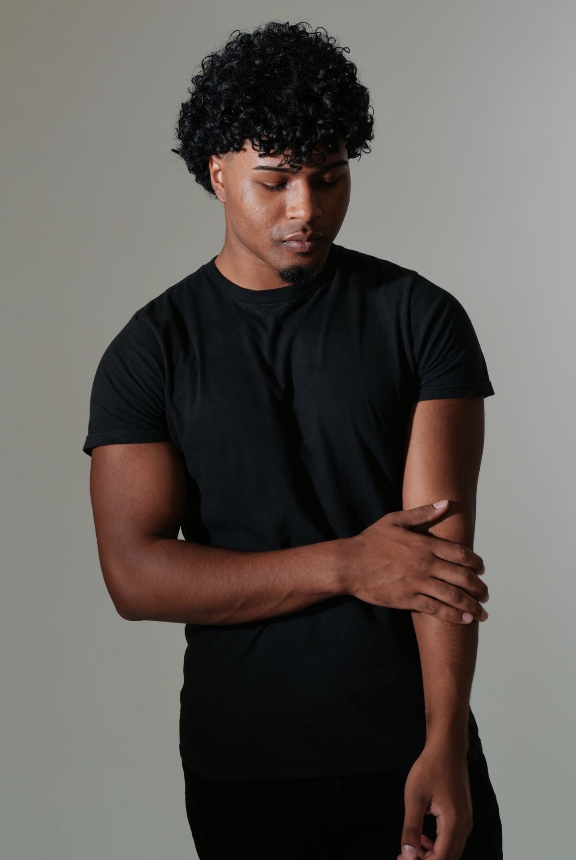 Close editorial portrait of Cole looking down