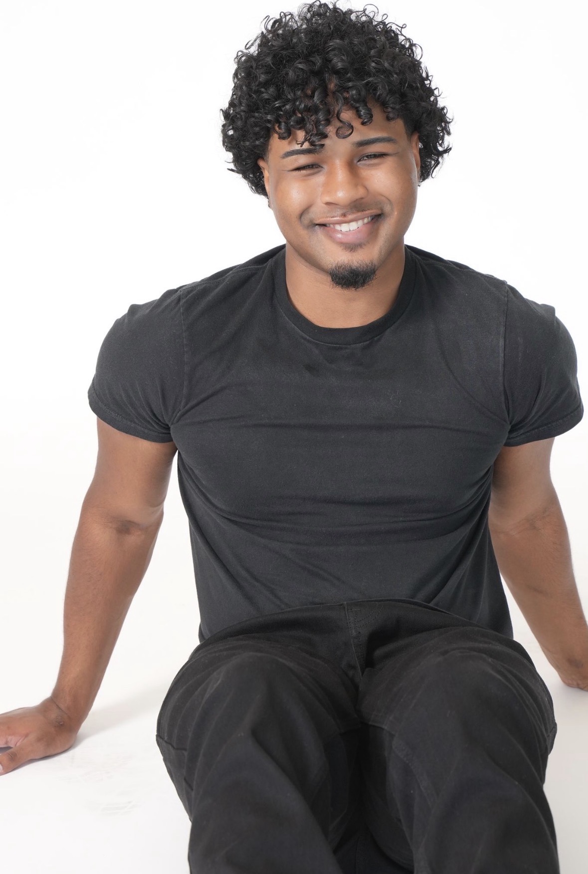 Cole seated and smiling
